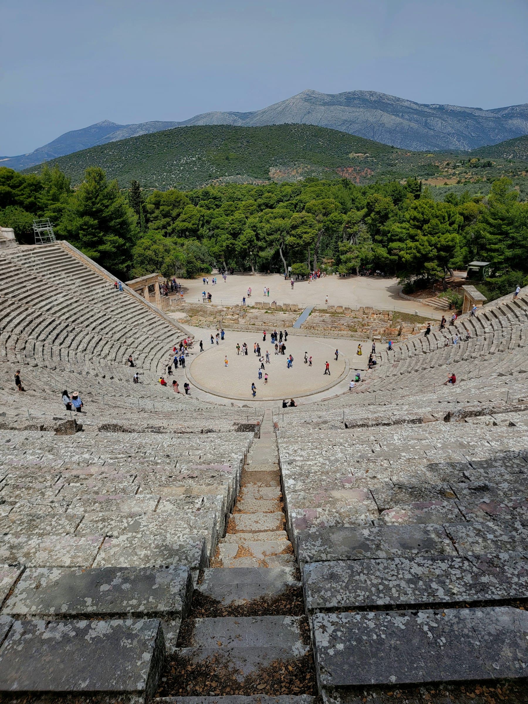 An ancient Greek amphitheater under a cloudy sky